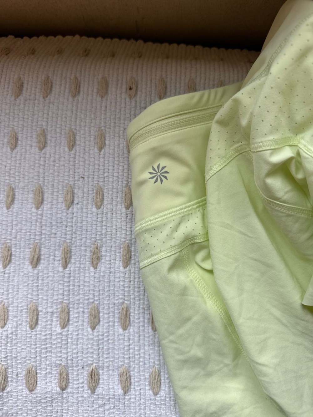 Athleta Pale Lime Run Short with Reflective Logo. Butter Yellow shorts.
